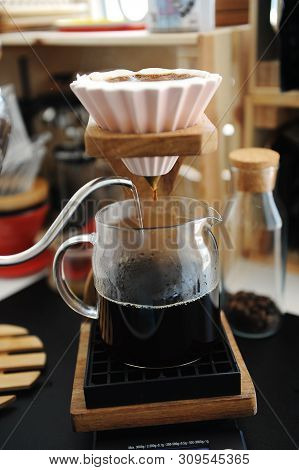 Brewing Coffee In Pink Ceramic Origami Dripper With Bypass. Wooden Stand. Alternative Manual Brew