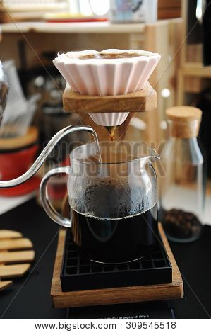 Brewing Coffee In Pink Ceramic Origami Dripper With Bypass. Wooden Stand. Alternative Manual Brew