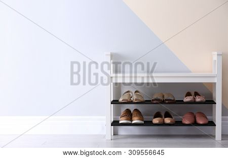 Shoe Rack With Different Footwear Near Color Wall, Space For Text. Stylish Hallway Interior