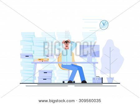 Tired And Exasperated Office Worker Is Grabbed His Head Among Piles Of Papers And Documents. Stress