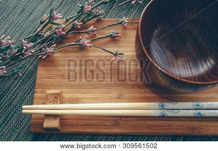 View From Above On Asian Style Tablewear Decorated With Branch Of Paper Flowers