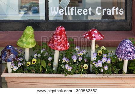 Wellfleet, Ma - June 12, 2019: Colorful Ceramic Toadstool Garden Accessories Displayed In A Flower B