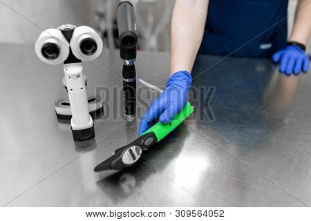 Medical Professional Ophthalmologist Tools Like Slit Lamp, Ophthalmoscope, Tonometer Lay On Metal Ta