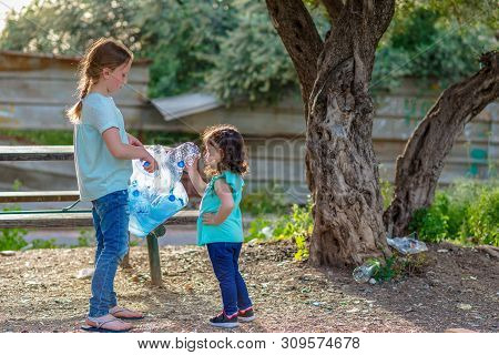 Two Kids Volunteer Charity Environment.children With Garbage Bags Cleaning Up Polluted Environmental