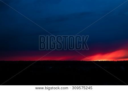 Evening Sky At Sunset Background. Dark Clouds Hanging Above Horizon. Majestic Cloudscape In Blue, Or