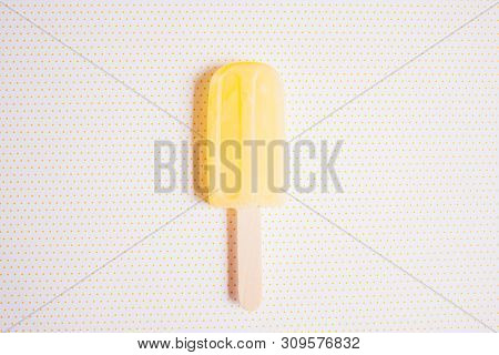 Ice Cream Shaped Lollipop On Yellow White Polka Dod Background.