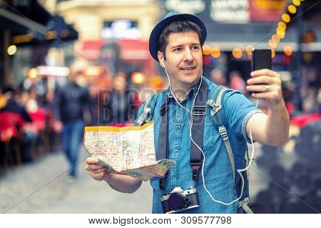 Smiling Man Tourist In London Taking A Selfie On Crowded Streets Full Of Pubs - Happy Middle Aged Ma