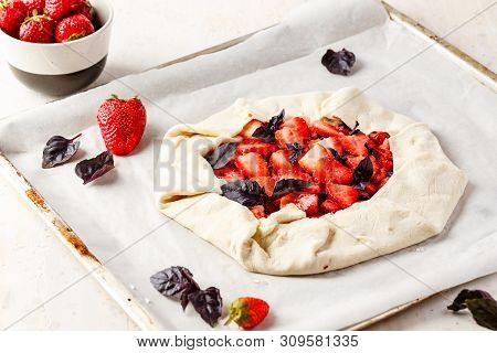 Homemade Strawberry Open Cake Of Gallet With Purple Basil And Balsamic Sauce Before Baking On A Ligh