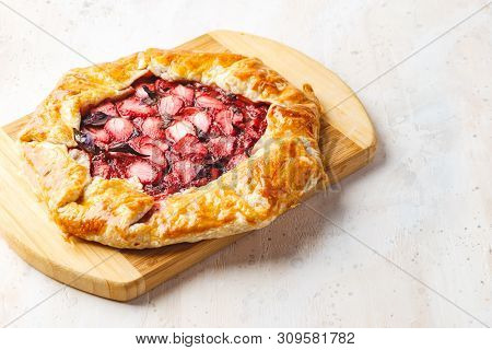 Homemade Strawberry Open Pie Gallet With Purple Basil And Balsamic Dressing On A Light Background.