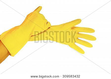 Female Hands In Yellow Working Rubber Gloves For Cleaning And Cleanliness Of The Room, Photo Close U
