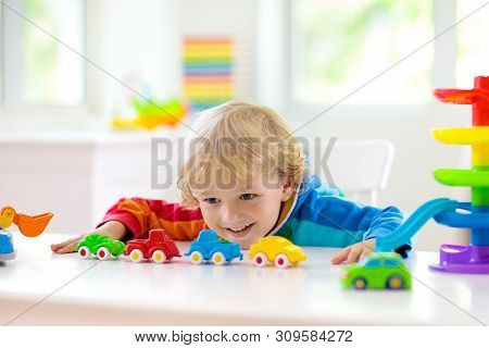 Boy Playing Toy Cars. Kid With Toys. Child And Car