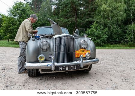 Wiecbork, Kujawsko Pomorskie / Poland - July 3, 2019: Rally Beijing - Paris. The Athlete Repairs The