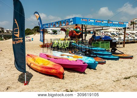 Mil Palmeras, Costa Blanca, Spain - July 02 2019: People On Beach Enjoying The Sun And Playing On In