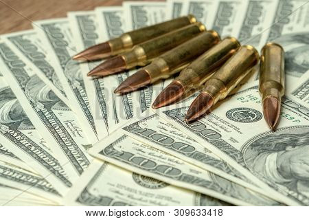 6 Rifle Cartridges On Hundred Dollar Bills. Concept For Crime, Contract Killing, Paid Assassin, Terr