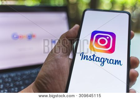 Chiang Mai, Thailand - May.26,2019: Man Holding Xiaomi Mi Mix 3 With Instagram Application On The Sc