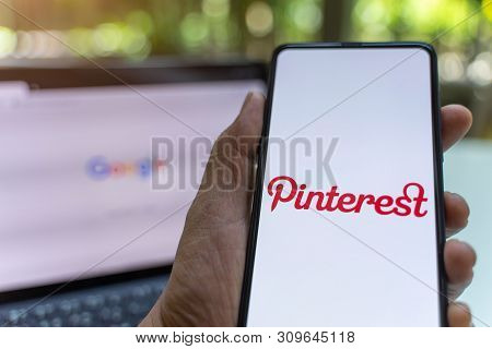 Chiang Mai, Thailand - May.26,2019: Man Holding Xiaomi Mi Mix 3 Mobile Phone With Pinterest Apps Log