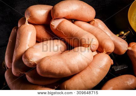 Closeup Bunch Of Short Thick Wieners Rolled In Spiral On Scales