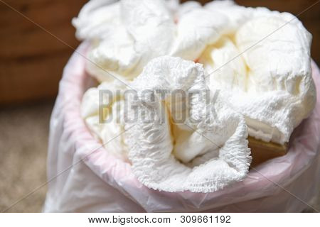 Diapers Waste / Dirty Diapers In A Garbage Pail Disposing Of Used Baby Nappies