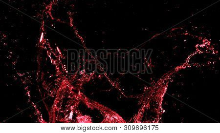 Abstract red wine splash shape on black background. Bavaragers and drink graphic element