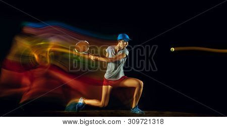 One Caucasian Woman Playing Tennis Isolated On Black Background In Mixed And Stobe Light. Fit Young 
