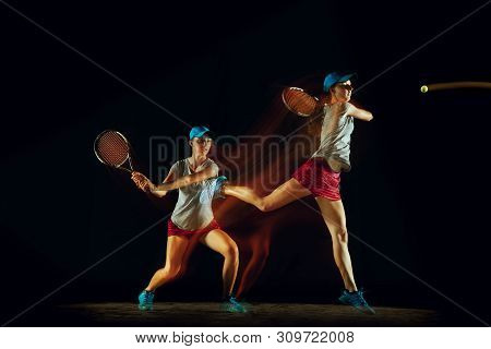 One Caucasian Woman Playing Tennis Isolated On Black Background In Mixed And Stobe Light. Fit Young 