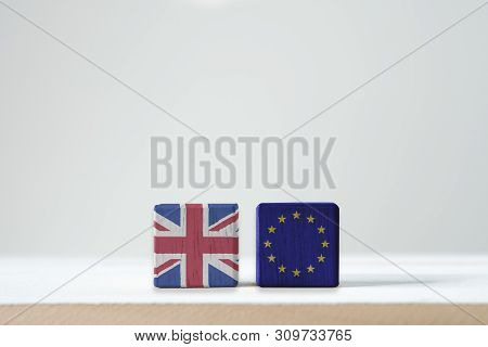 Eu Flag And British Flag Print Screen On Wooden Cubic With White Background. It Is Symbol Of British