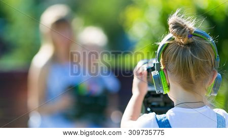 The Child Makes His First Videos On Street In The City Park Girl Novice Videoblogger Shoots At The C