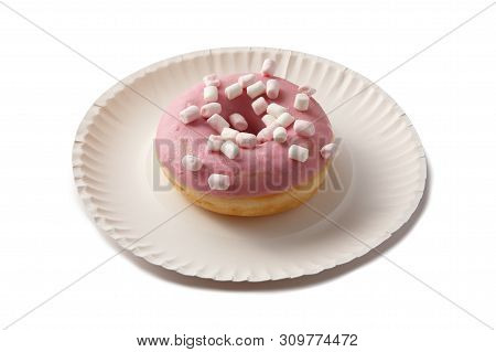 Sweet Doghnut In Pink Glaze Decorated With Sprinkles On A Paper Plate Isolated On A White Background