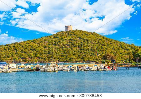 View Of Gulf, Pier And Beach Of Tramariglio In A Sunny And Cloudy Day, In The Capocaccia Coast