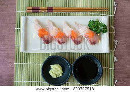 Hamachi Sushi On White Plate Along With Japanese Sauce And Green Leaf Decoration, Japanese Food, Top