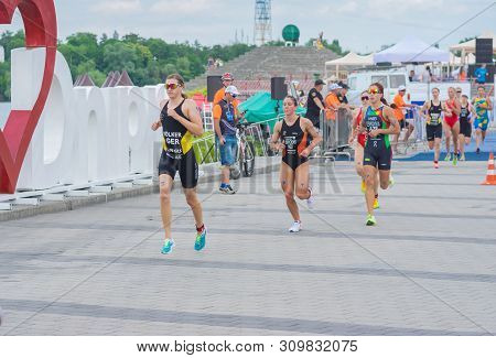 Dnipro, Ukraine - June 08, 2019: Group Of Female Athletes Running On A City Embankment During Of The