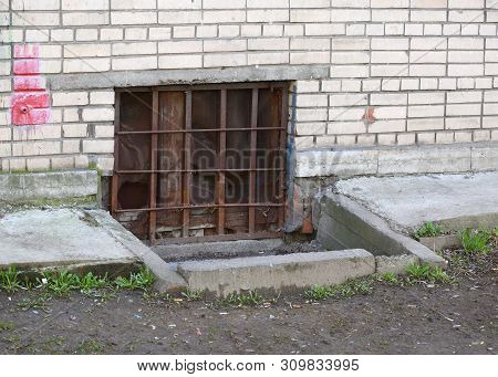 The Basement Window With A Metal Barrier