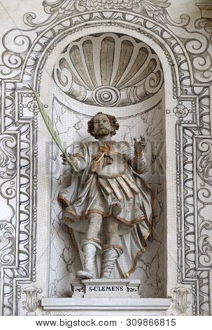 LUCERNE, SWITZERLAND - JUNE 24, 2018: Saint Clement statue on the facade of the church of St. Leodegar in Lucerne, Switzerland
