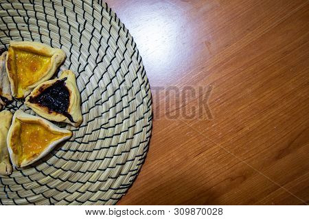 Hamantash Purim Blueberry And Apricot Jam Cookies With Wooden Table Background