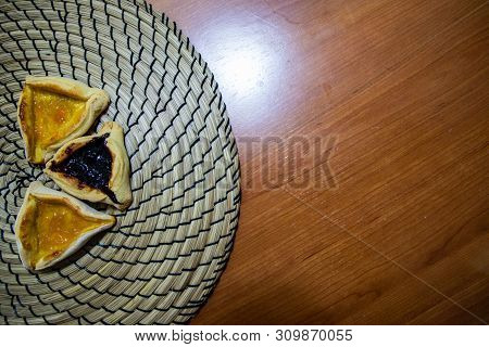 Hamantash Purim Blueberry And Apricot Jam Cookies With Wooden Table Background