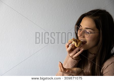 Beautiful And Happy Women Portrait Eating Hamantash Purim Apricot Cookie