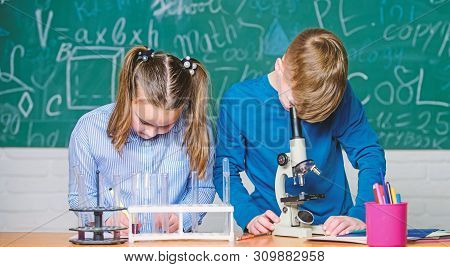 Kids Study Chemistry. School Chemistry Lesson. School Laboratory. School Education. Girl And Boy Com