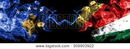 Kosovo Vs Seychelles, Seychelloise Smoky Mystic Flags Placed Side By Side. Thick Colored Silky Smoke