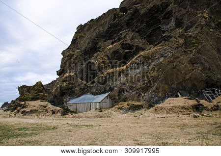 Old Stone House Destroyed Ancient Viking Overgrown With Yellow Dry Grass In Iceland