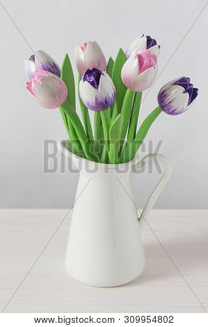 Wooden Tulips Artificial Flowers Pink Violet In A White Jug, Vertical. Flower Still Life In Bright C