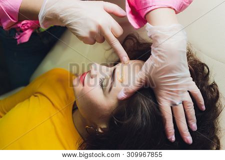 Depilation With Hot Wax Mustache In The Beauty Salon. Young Woman Receiving Facial Epilation Close U