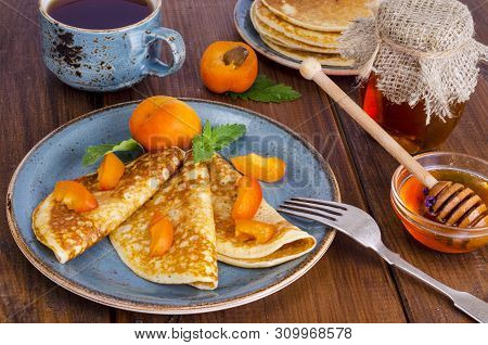 Wheat Pancakes With Honey And Apricots. Photo
