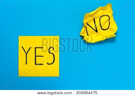 Close Up Black Handwritten Inscription Yes And No Word On Two Yellow Square Stickers On Blue Backgro