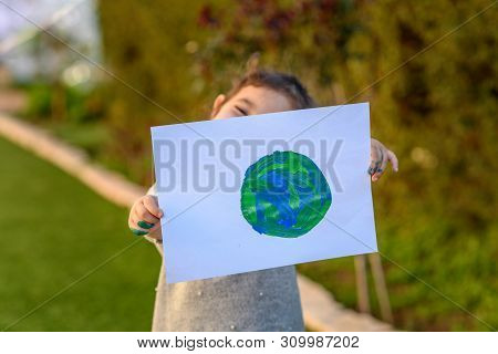 Portrait Of The Cute Little Girl Holding The Drawing Earth Globe. Child Drawng A Picture Of Earth.