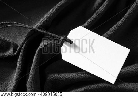White Empty Label On Black Cloth Background