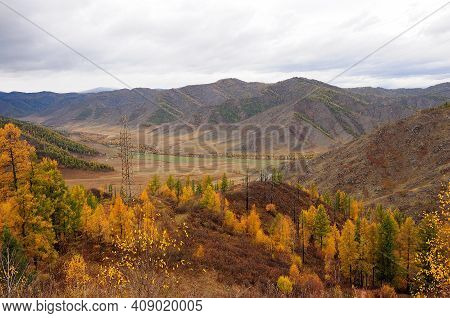 A View From The Top Of The Hill To The Picturesque Autumn Valley And The Electric Columns Passing Th