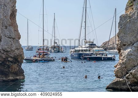 Vis, Croatia - Aug 17, 2020: People Swim At The Inlet Of Sheltered Stiniva Beach Shore In Summer