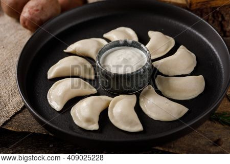 Appetizing Traditional Russian Dumplings, Hand-made With Potatoes. Still Life On A Wooden Board. Clo