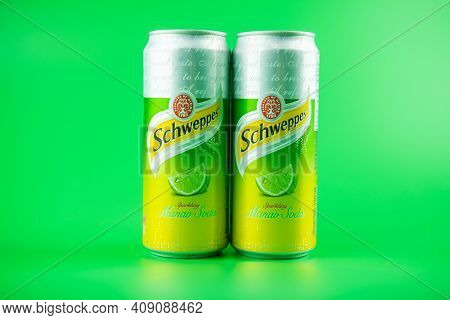 Bangkok, Thailand - February 21, 2021 : Photo Two Can Of Schweppes Manao Soda On A Green Background.
