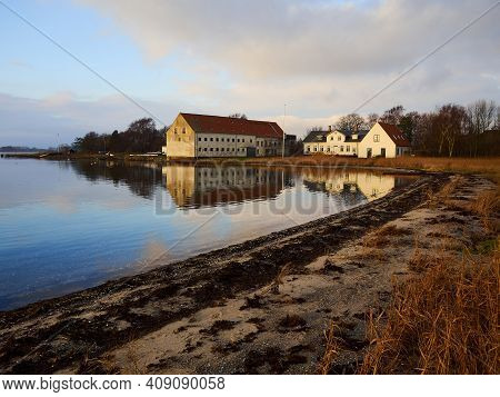 Magical Tranuil Beautiful With Clear Calm Water Sunset With Great Clouds Formation By The Sea Shore 